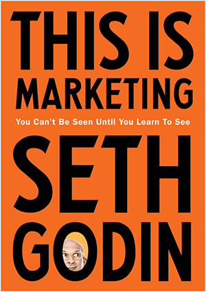 Tai Setho Godino „This Is Marketing“ viršelio ekrano kopija. Viršelis yra vertikalus stačiakampis su oranžiniu fonu ir juodu tekstu. Setho galvos nuotrauka pasirodo jo pavardės O.
